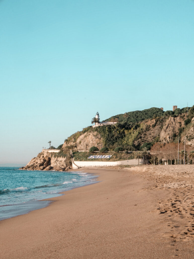 Playa de Garbí de Calella con el faro de la ciudad y con vistas a las calas de Calella Barcelona Cataluña